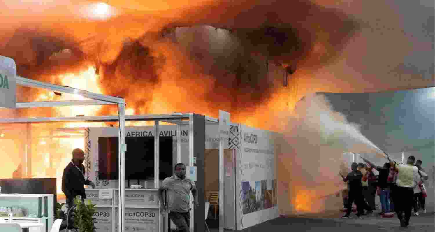 People use fire extinguishers to put out a fire at the Pavilion of Countries in the Blue Zone at the United Nations Climate Change Conference (COP30) in Belem in Brazil on Thursday.