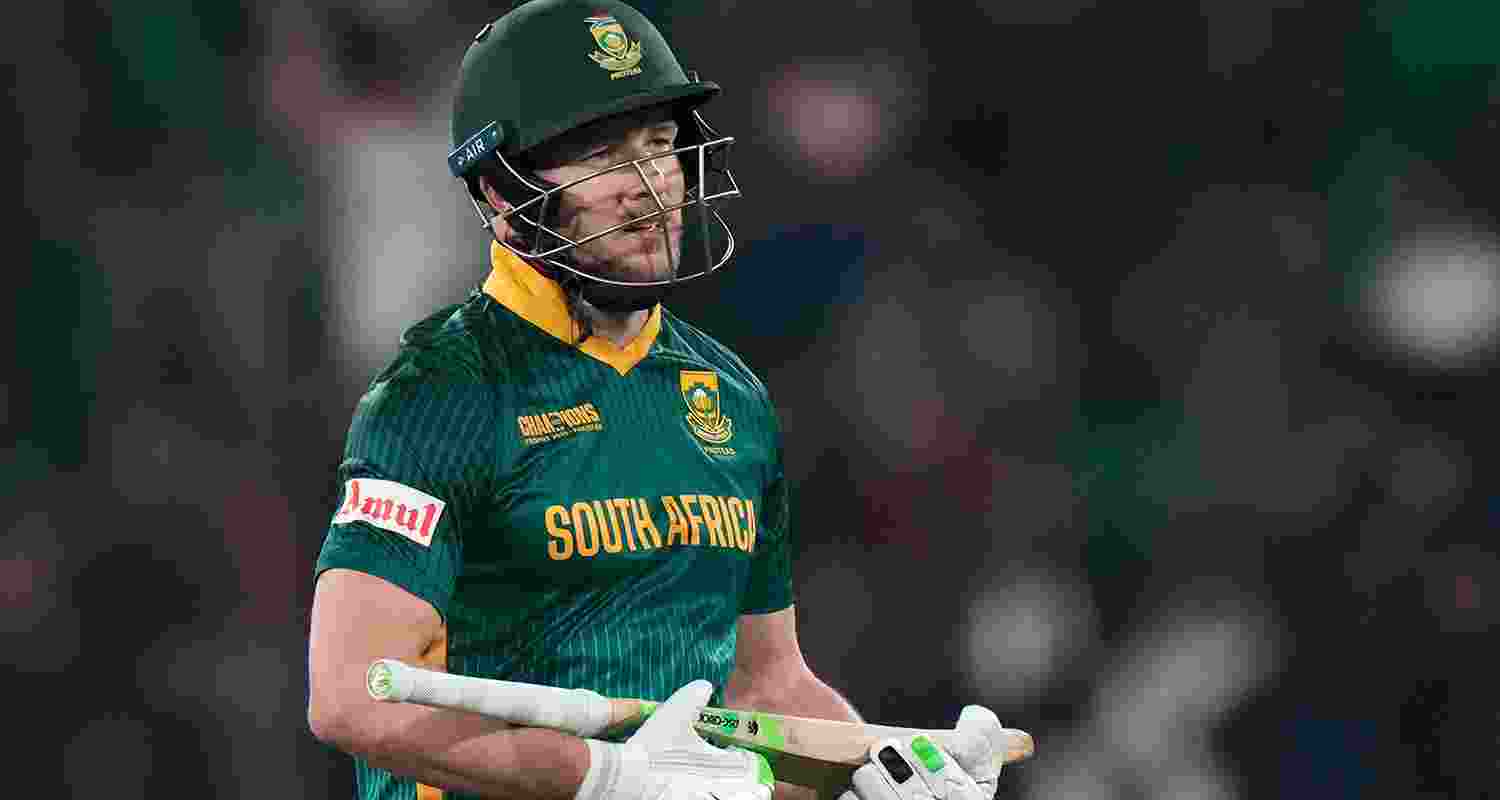 David Miller cradles his bat after scoring a century during the ICC Champions Trophy semifinal cricket match between New Zealand and South Africa at Gaddafi Stadium in Lahore, Pakistan, on Wednesday.