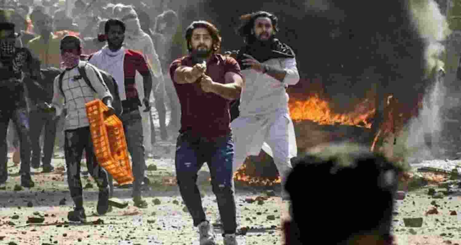 Shahrukh Pathan, points a pistol during the 2020 northeast Delhi riots.
