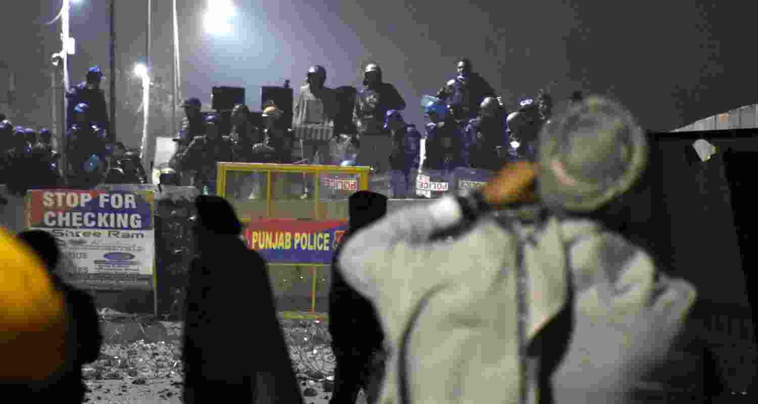 Security personnel stand guard at a roadblock at the Shambhu Border amid farmers' protest during the Samyukta Kisan Morcha. 