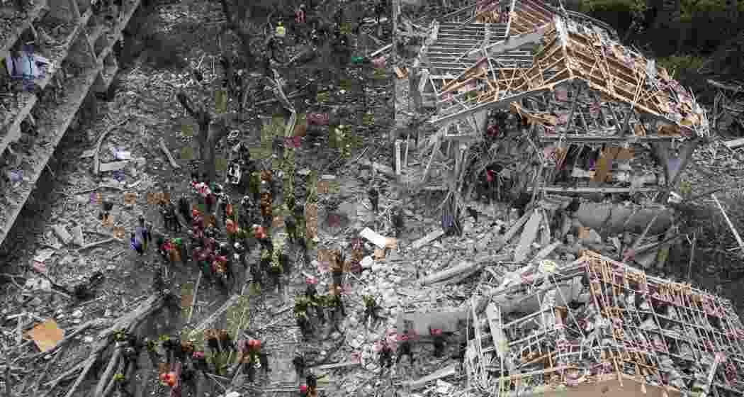 Firefighters, rescue workers and military work at the site of a direct missile strike launched from Iran in Tel Aviv, Israel, on Sunday.