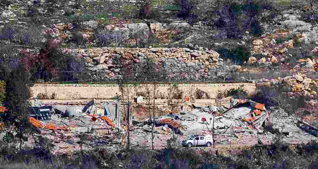 Captured from northern Israel near the Lebanon border, this image shows civilian vehicles navigating past destroyed buildings in Aita al-Shaab, southern Lebanon, on January 29, 2025.