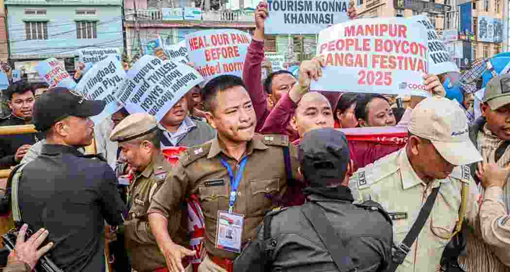 Protesters being confronted by security forces as they march towards the Sangai Festival venue in Imphal.