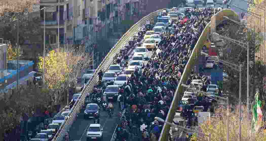 Demonstrators march through streets in Iran as protests over economic hardship spread nationwide, with at least 10 people reported dead.