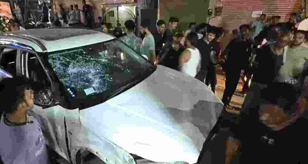 Locals gather at the scene in Jaipur where a speeding SUV driven by an intoxicated man mowed down pedestrians and vehicles over a seven-kilometre stretch, killing three people.