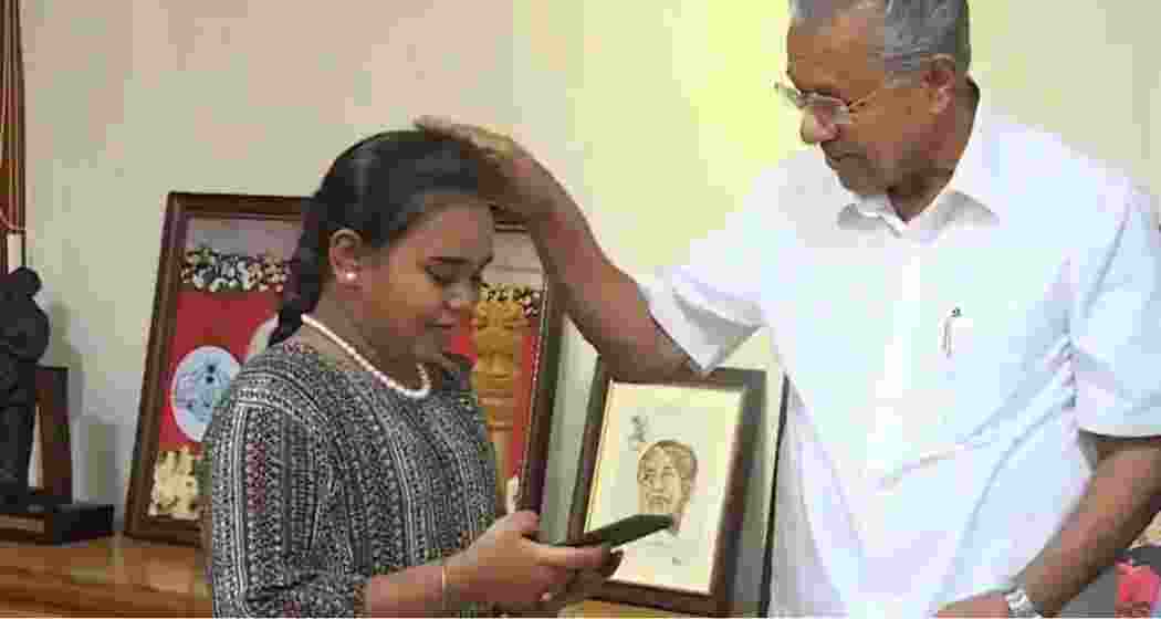 Kerala CM Pinarayi Vijayan blesses Harini Sri for her heartfelt contribution to the Wayanad relief fund.