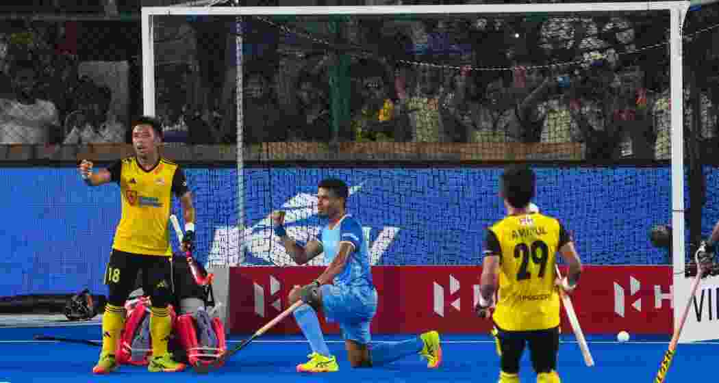 India's Shilanand Lakra celebrates after scoring a goal during a men's hockey Asia Cup match between India and Malaysia in Rajgir, Bihar, on Thursday.