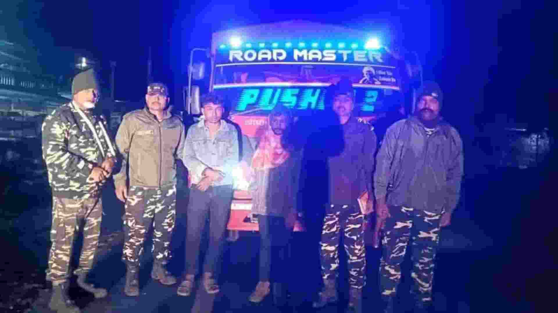 SSB personnel pose with the seized truck and arrested cattle smugglers after a high-speed chase near the India–Nepal border in Naxalbari.