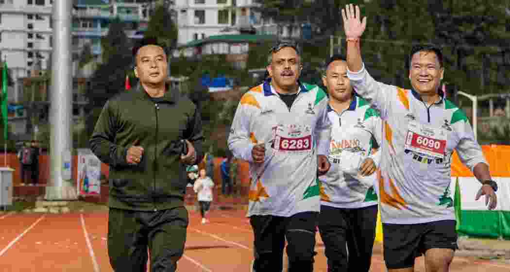 Arunachal Pradesh Chief Minister Pema Khandu (right) participates in the Tawang Marathon, in Tawang on Oct. 1, 2023.
