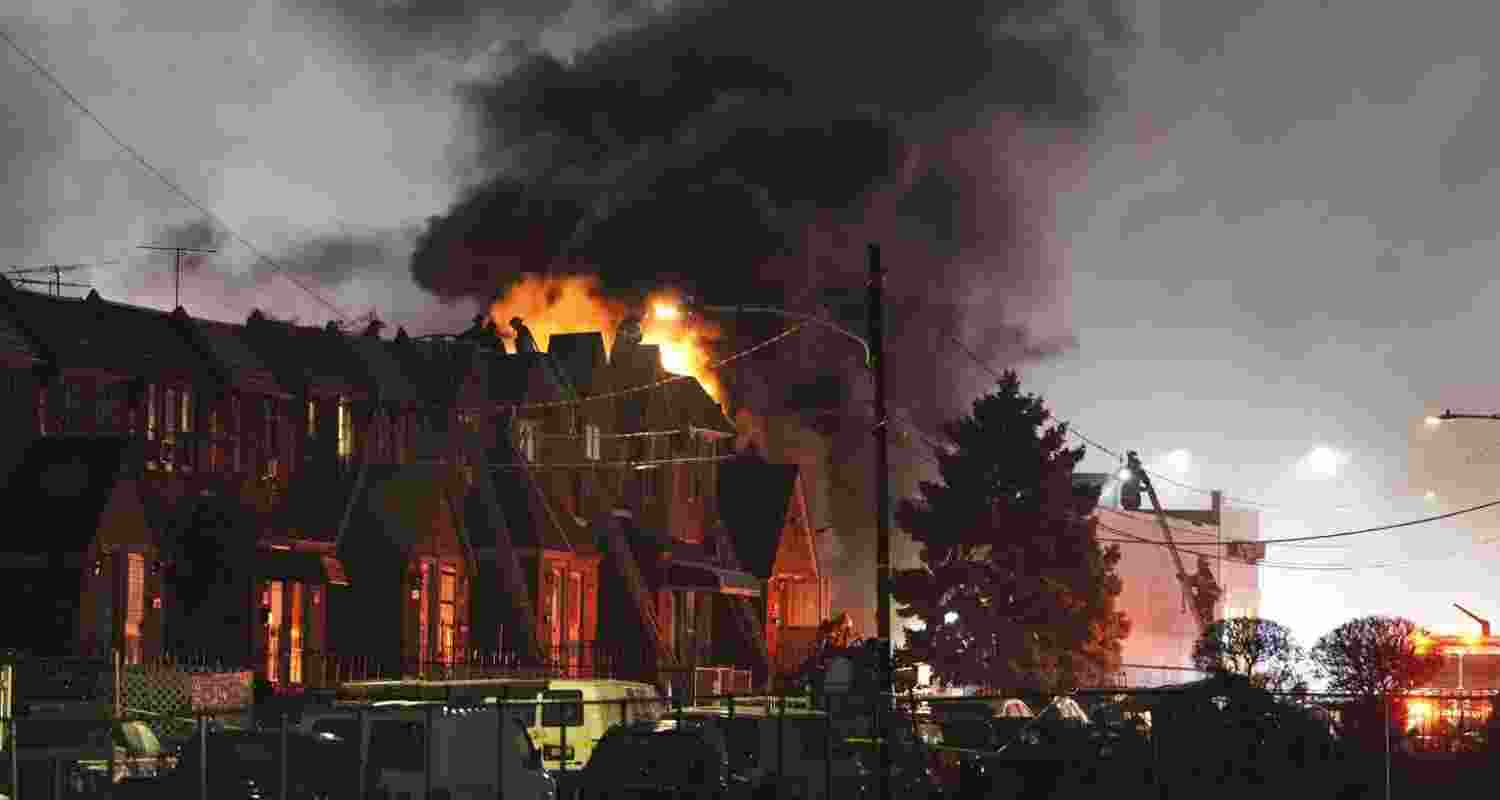 Smoke and flames rise from the site where the plane crashed. Image via X.