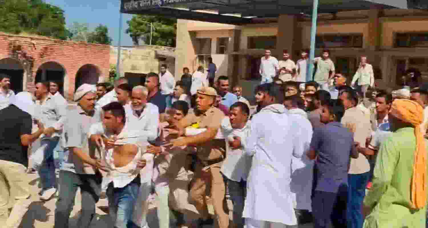 Supporters of Congress and BJP clash during Haryana Assembly elections, in Narnaud area of Hisar, Saturday. 