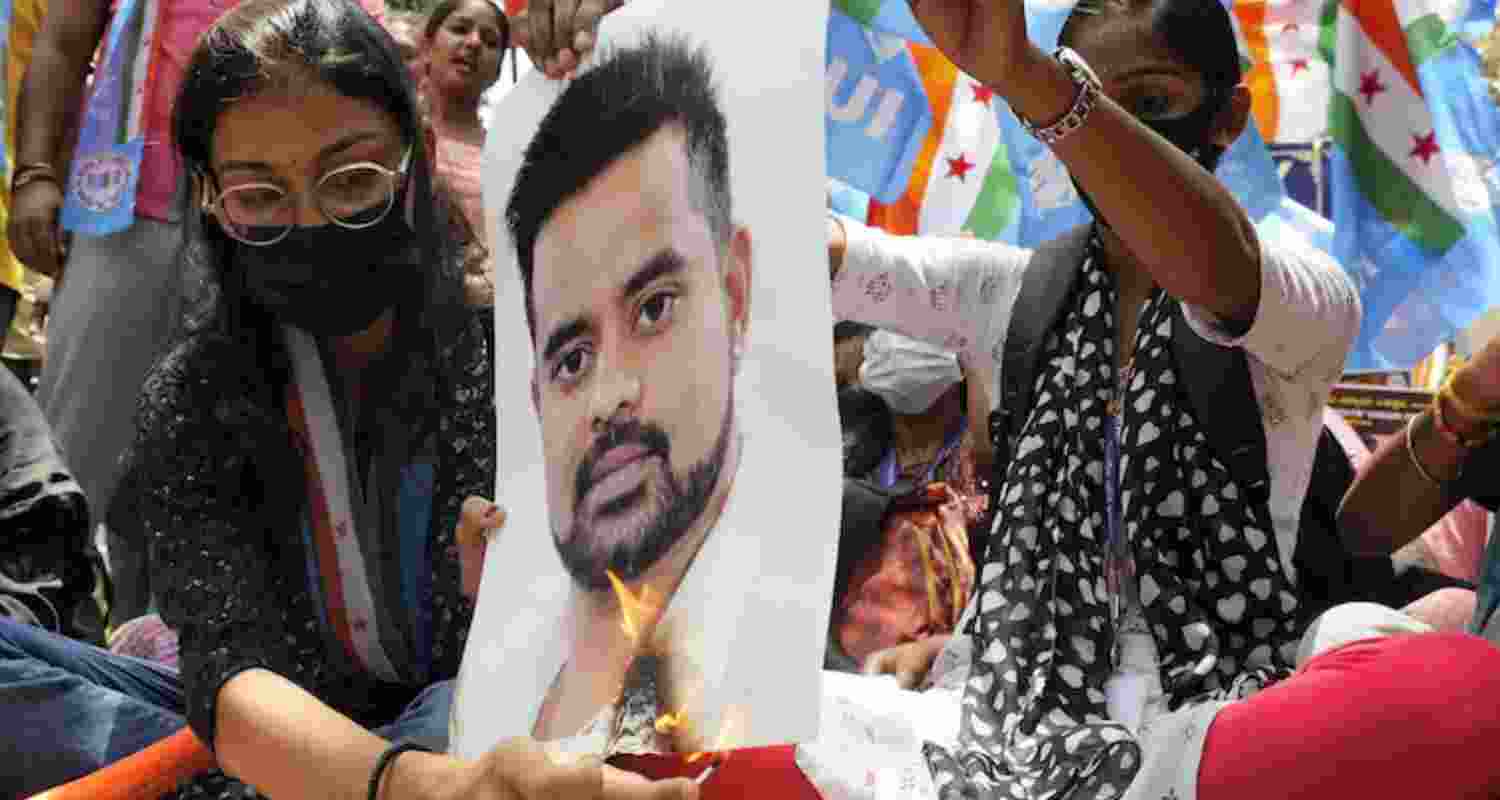 People burning Prajwal's poster. 