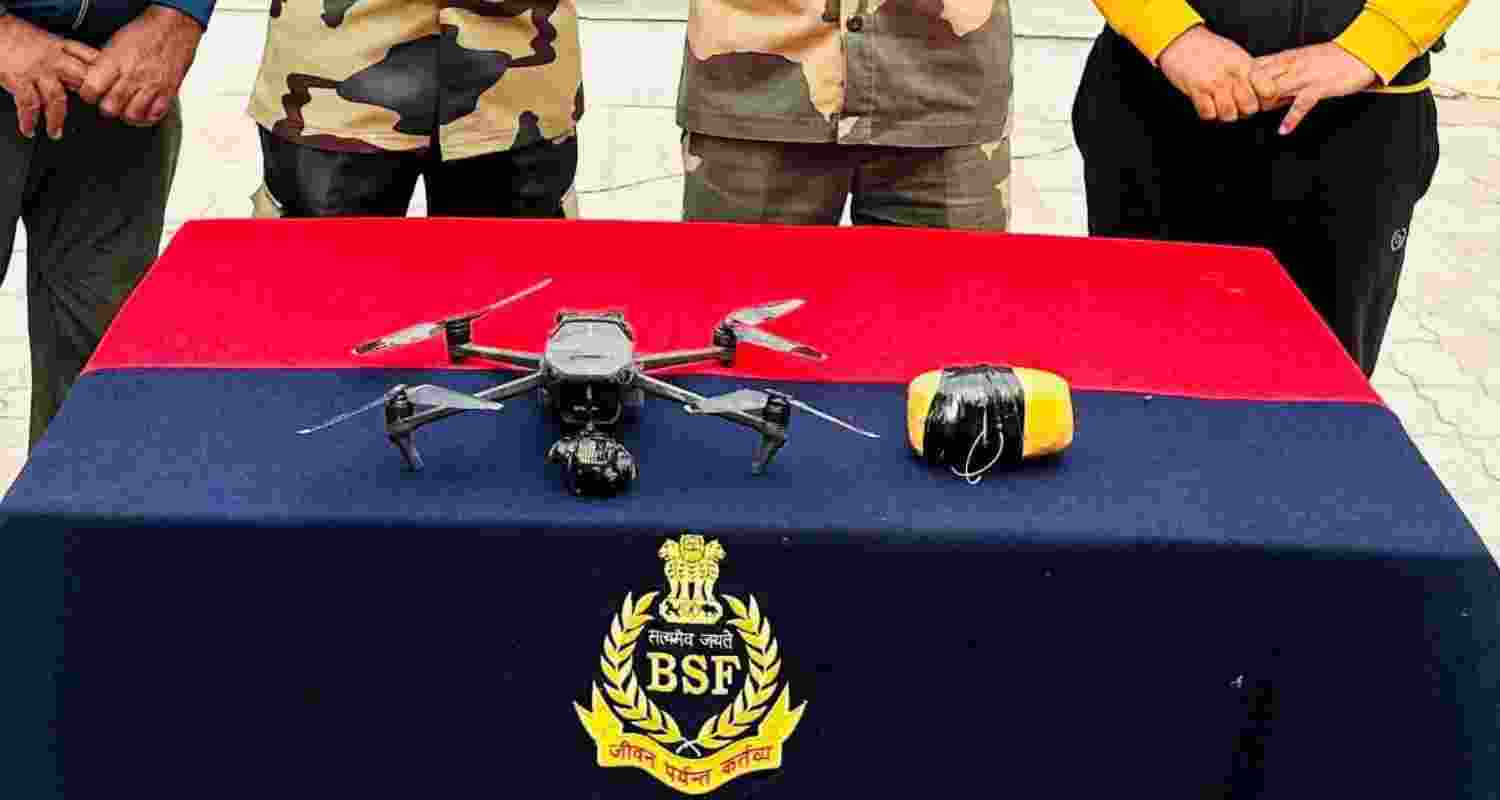 BSF officials with the seized drones and contraband.