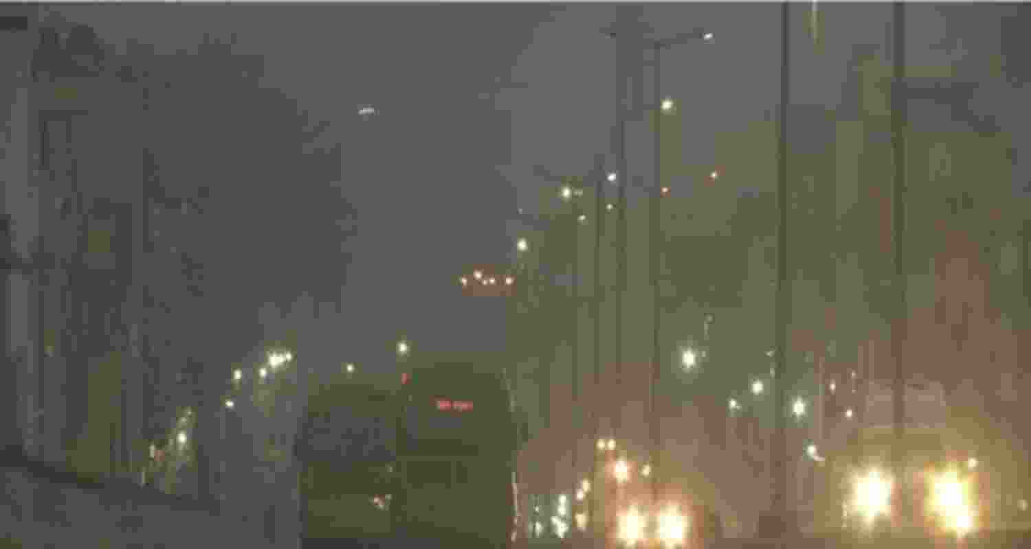 Vehicles move through fog on a cold winter morning, in New Delhi.