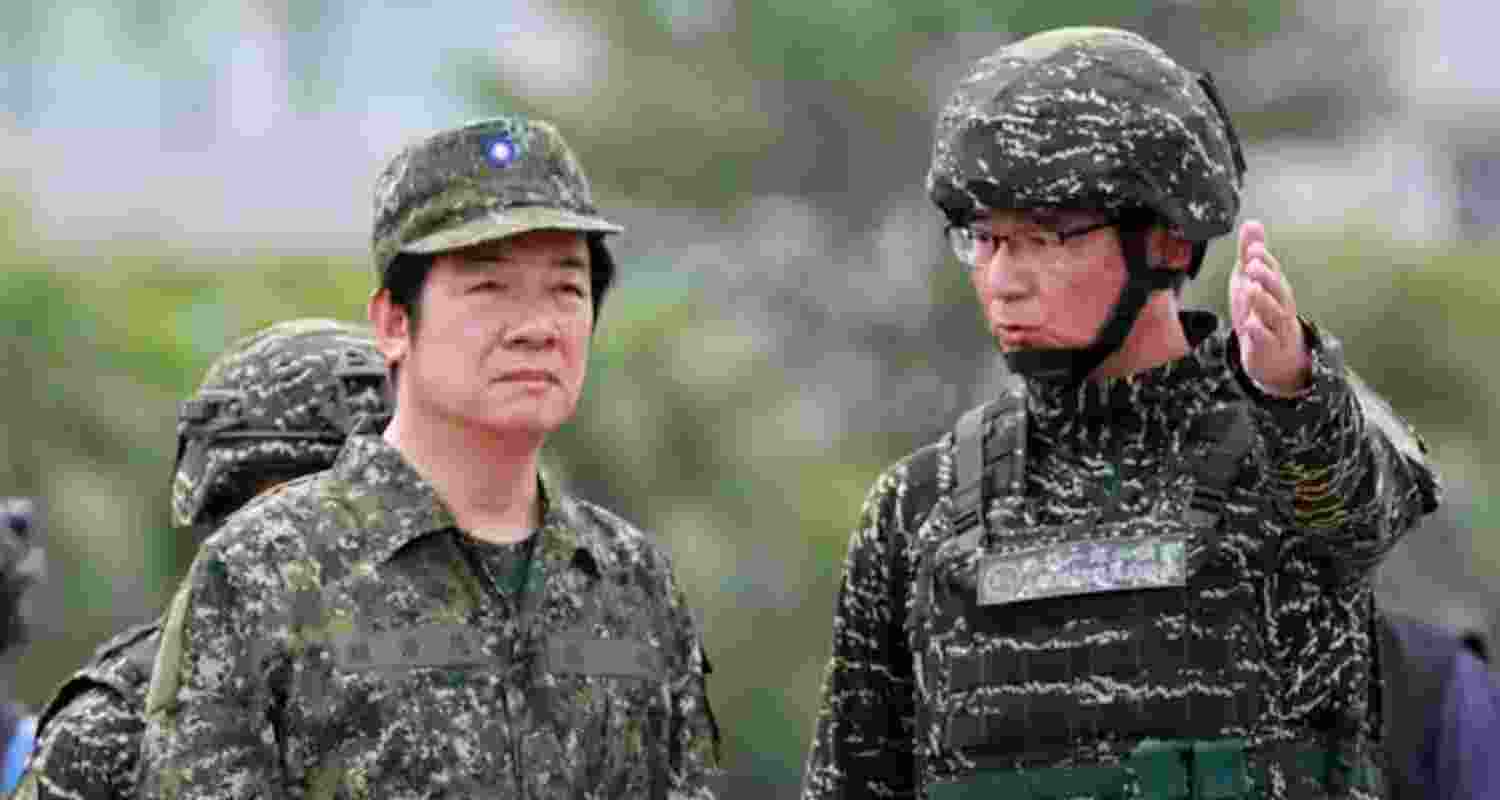Taiwanese president, William Lai Ching-te (left) attempts a drill inside a naval base in Kaohsiung city, Taiwan, in July 2025.