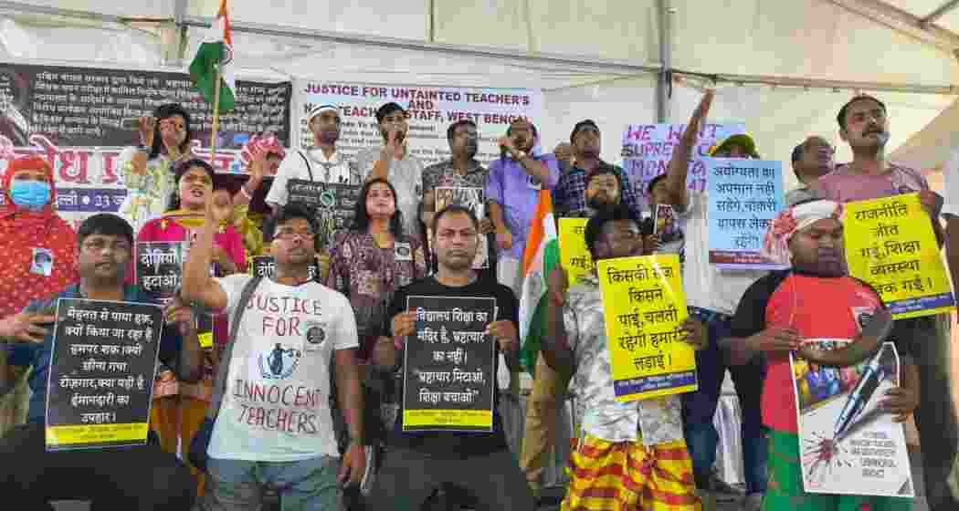 ‘Untainted’ teachers and non-teaching staff stage a protest in New Delhi as courts refuse to halt the new school recruitment process, leaving axed educators seeking relief.