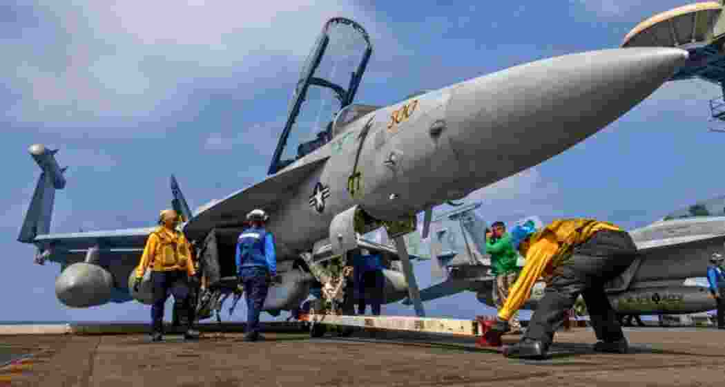 This photo provided by the US Navy shows sailors preparing a Boeing EA-18G Growler on the flight deck of the Nimitz-class aircraft carrier USS Abraham Lincoln in the Indian Ocean.