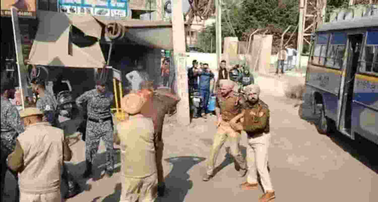 A video grab of policemen rushing to the rescue of Dhuri police station SHO Jasvir Singh, who suffered burns after his uniform caught fire during a clash with protesters outside the Sangrur bus stand on Friday morning. Some protesters perched atop buses were carrying petrol in bottles.