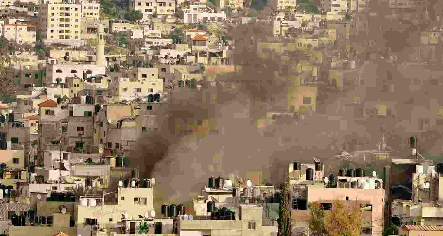 Smoke rises through buildings after an Israeli airstrike in Gaza. Image via X.