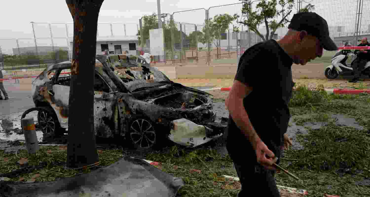 A man inspects the site of an Iranian missile strike in Petah Tikva, Israel, Wednesday. 