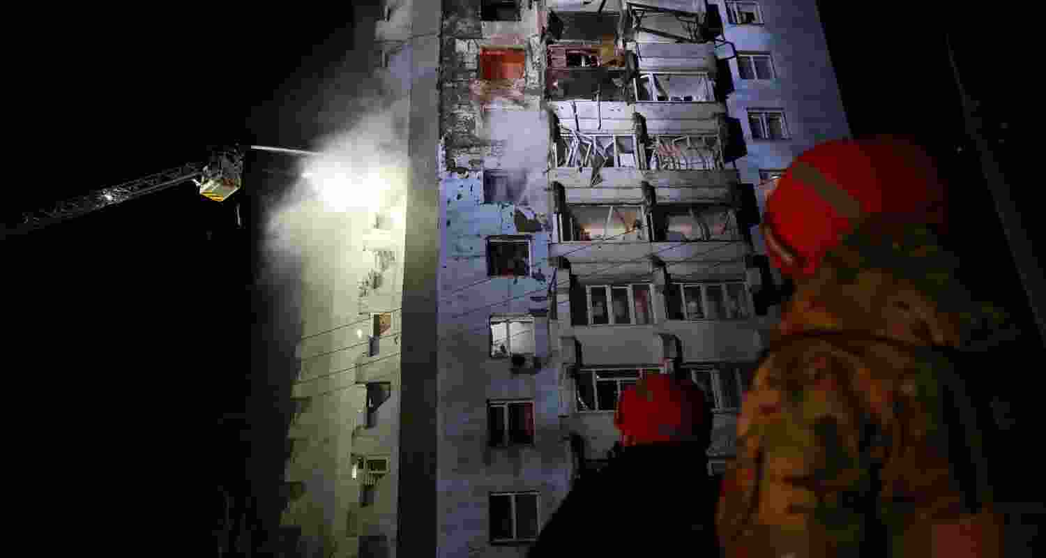 Rescue workers try to put out a fire of a residential building burning after a Russian drone attack on Zaporizhzhia, Ukraine, Tuesday. 