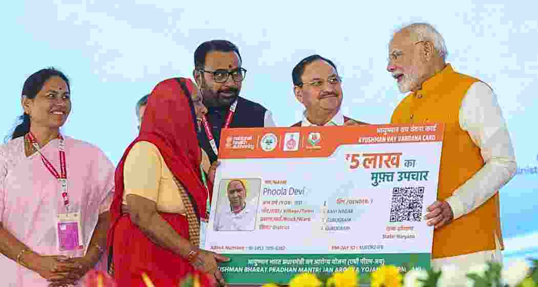 Prime Minister Narendra Modi hands over Ayushman Vaya Vandana Card to a beneficiary in New Delhi. (Image: PTI)