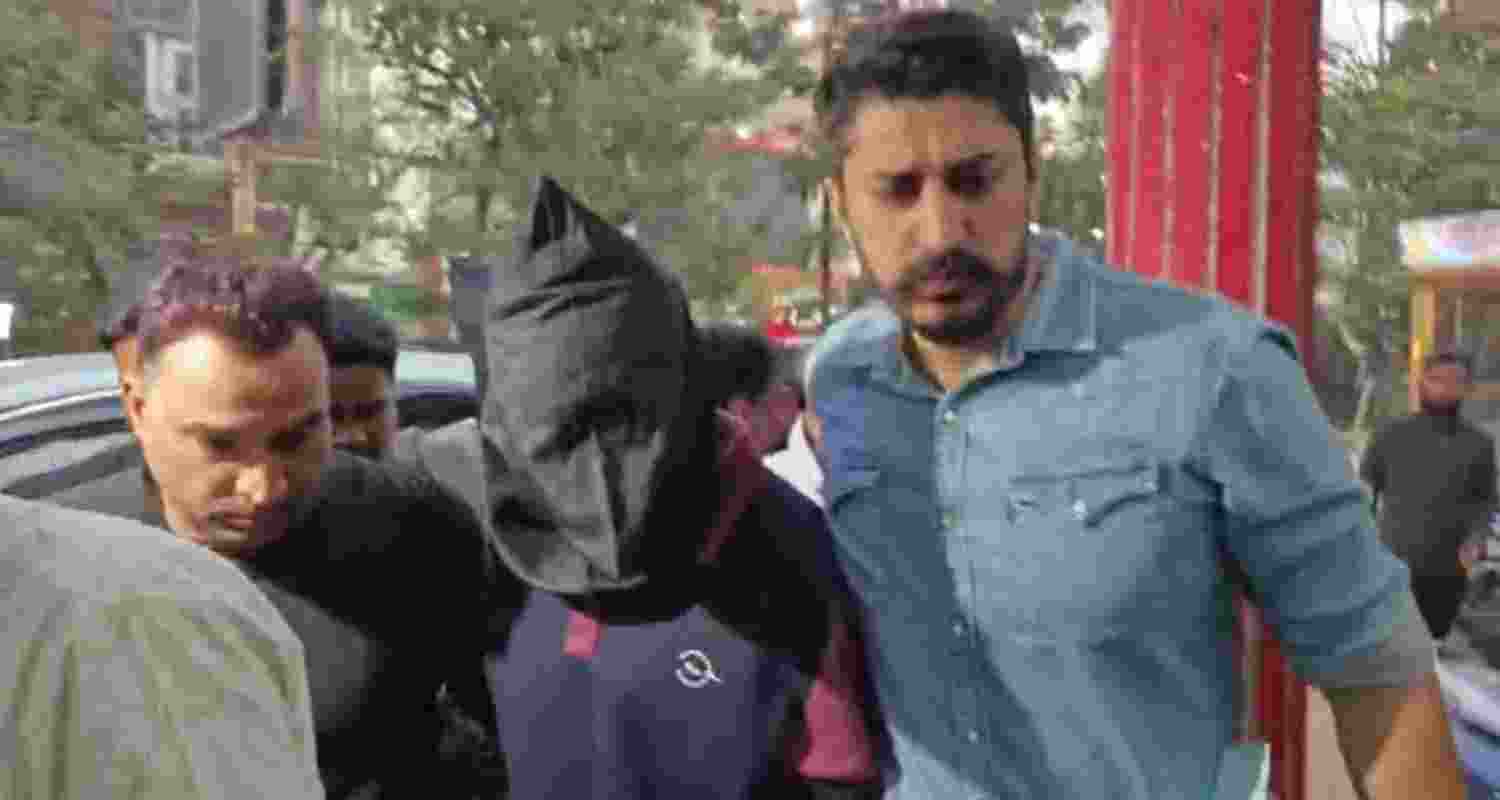 One of the alleged shooters in police custody.