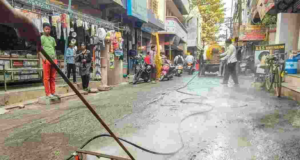 Municipal workers clear roads during sanitation drives following the typhoid outbreak in Gandhinagar.