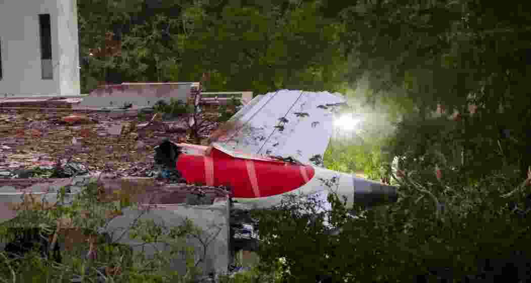 Remains of the Air India plane that crashed moments after taking off from the Ahmedabad airport, lies on a building in Ahmedabad, Thursday.