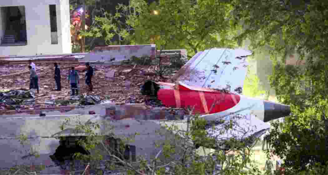 Local residents gather near the wreckage of the Air India aircraft that crashed into a dental hospital hostel in Ahmedabad shortly after takeoff on June 12. 