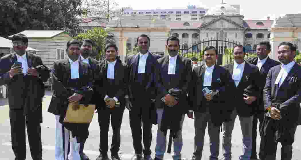 Lawyers come out after attending a meeting of Allahabad High Court Bar Association, in Prayagraj. 