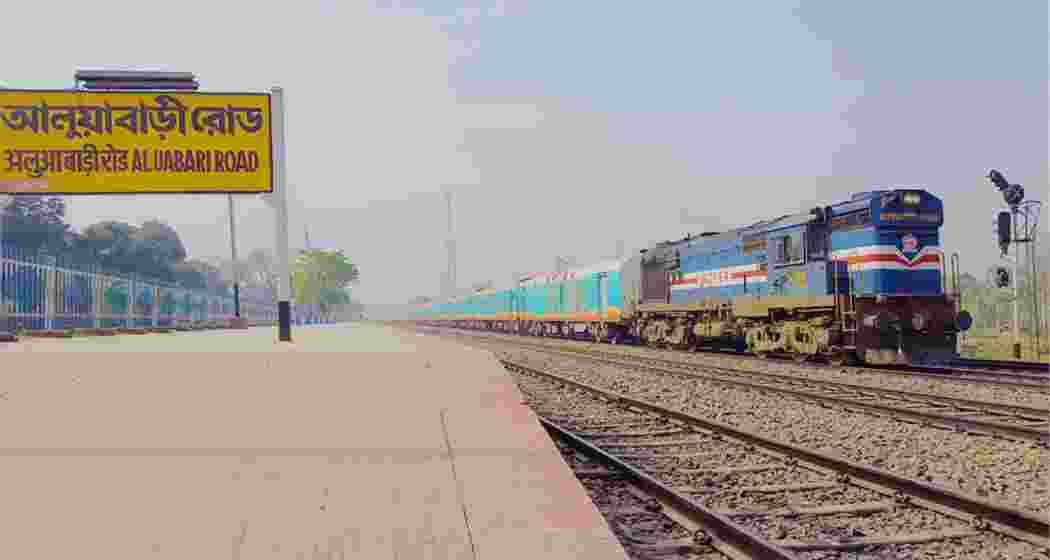A train at a halt at the Aluabari railway station. 