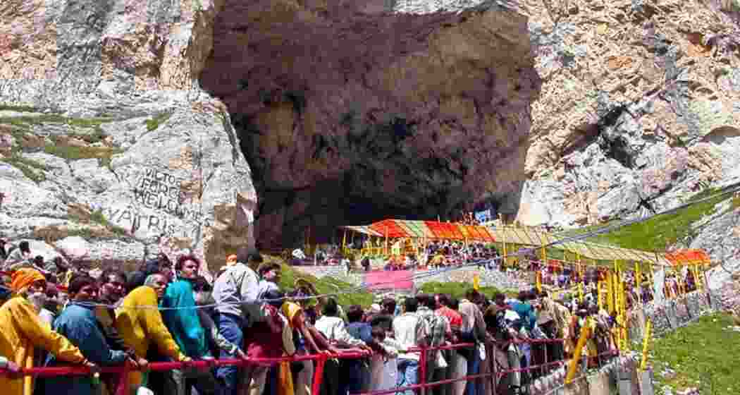 Pilgrims queue in disciplined silence outside the sacred Amarnath cave shrine, braving altitude and weather in their spiritual quest.
