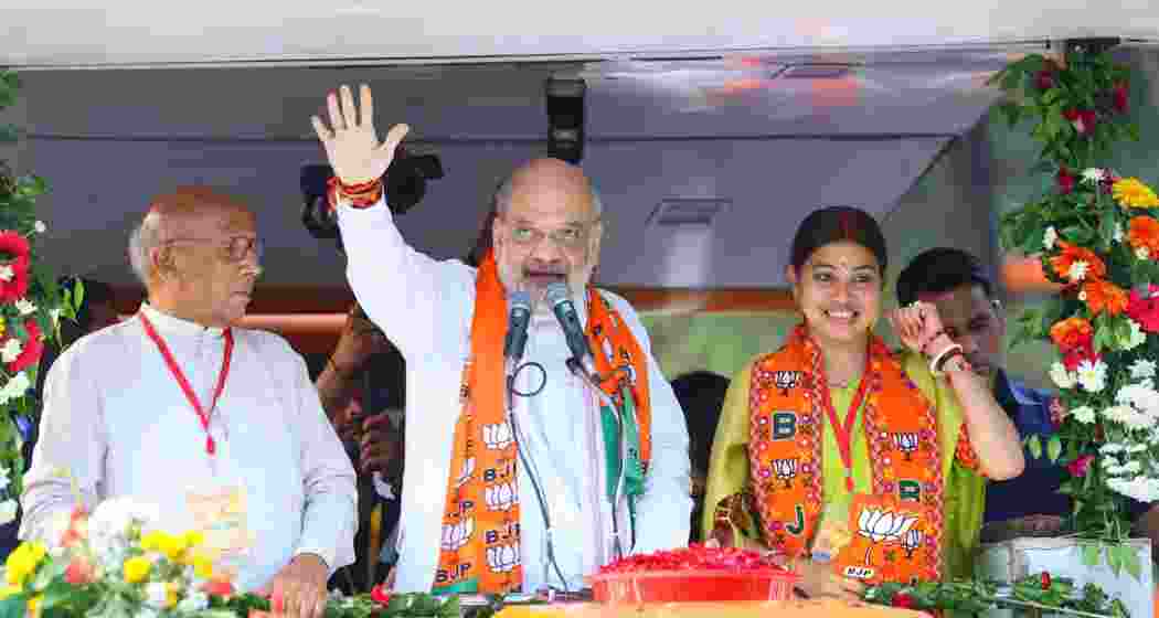 Union Home Minister Amit Shah waves to enthusiastic crowds during a grand roadshow in Jamshedpur, joined by NDA leaders Purnima Sahu and Saryu Roy, as part of BJP's comeback campaign in Jharkhand.