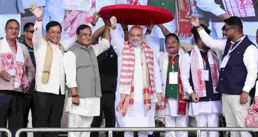 Union Home Minister Amit Shah being felicitated with a traditional Assamese 'japi', hat, during the 'Yuva Shakti Samaroh', in Guwahati, on Sunday. Union Minister of Ports, Shipping and Waterways Sarbananda Sonowal, Assam CM Himanta Biswa Sarma and BJP state President Dilip Saikia also seen.