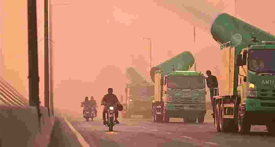 A thick haze blankets Lahore as residents navigate smog-choked streets, while anti-smog gun trucks patrol key areas, attempting to curb rising pollution levels across the city.