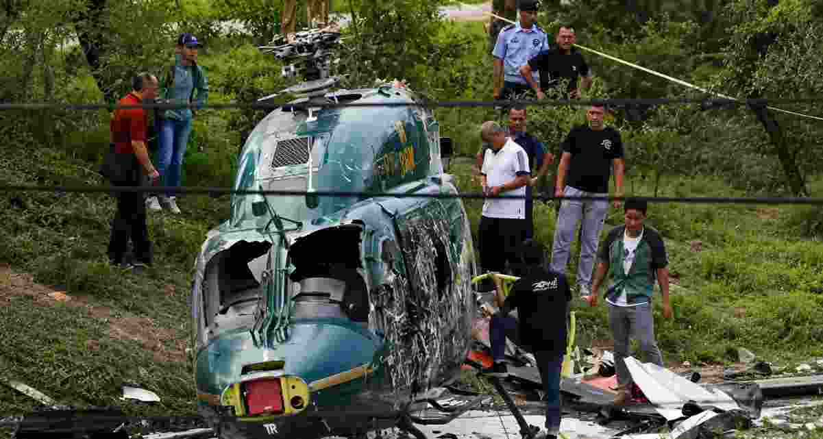 Rescue personnel respond after a Saudi Aramco helicopter crashed in Ras Tanura, Saudi Arabia, killing 14 people. Authorities have launched an investigation to determine the cause of the accident.