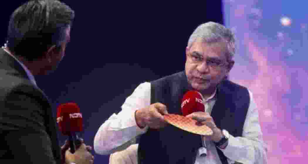 Union IT Minister Ashwini Vaishnaw displays a palm-sized 2nm semiconductor wafer. 