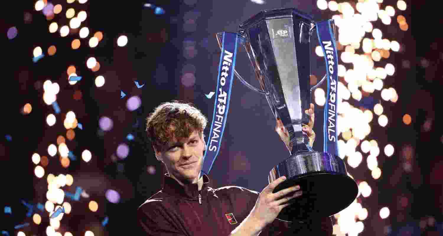 Italy's Jannik Sinner celebrates with the trophy after winning the ATP Finals title against Spain's Carlos Alcaraz in Turin, Italy.