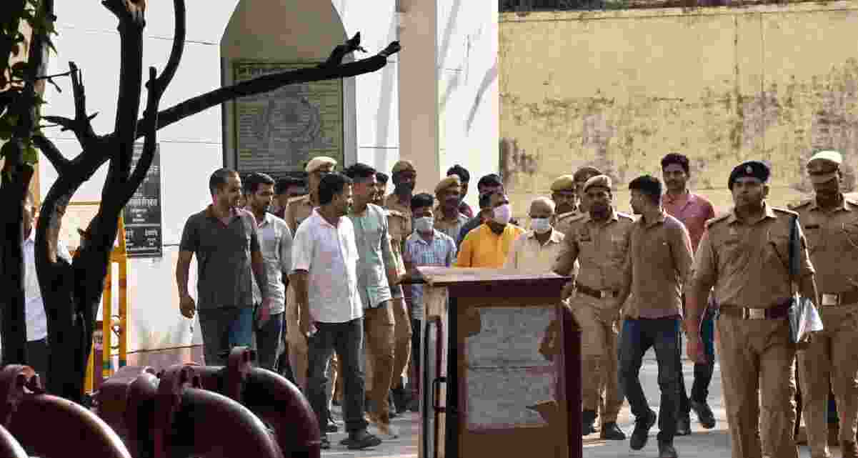 Police escort eight accused in the alleged Ram Mandir donation embezzlement case after they were produced before a court in Ayodhya, which remanded them to judicial custody till June 29.
