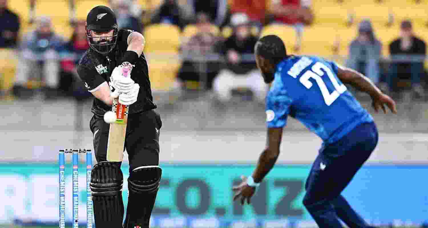Daryl Mitchell of New Zealand plays the ball towards England's Jofra Archer during the third one-day international in Wellington.