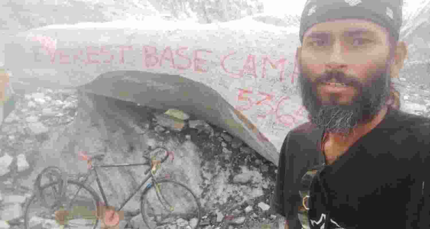 Bapi Debnath after reaching Mount Everest's South Base Camp on his bicycle.