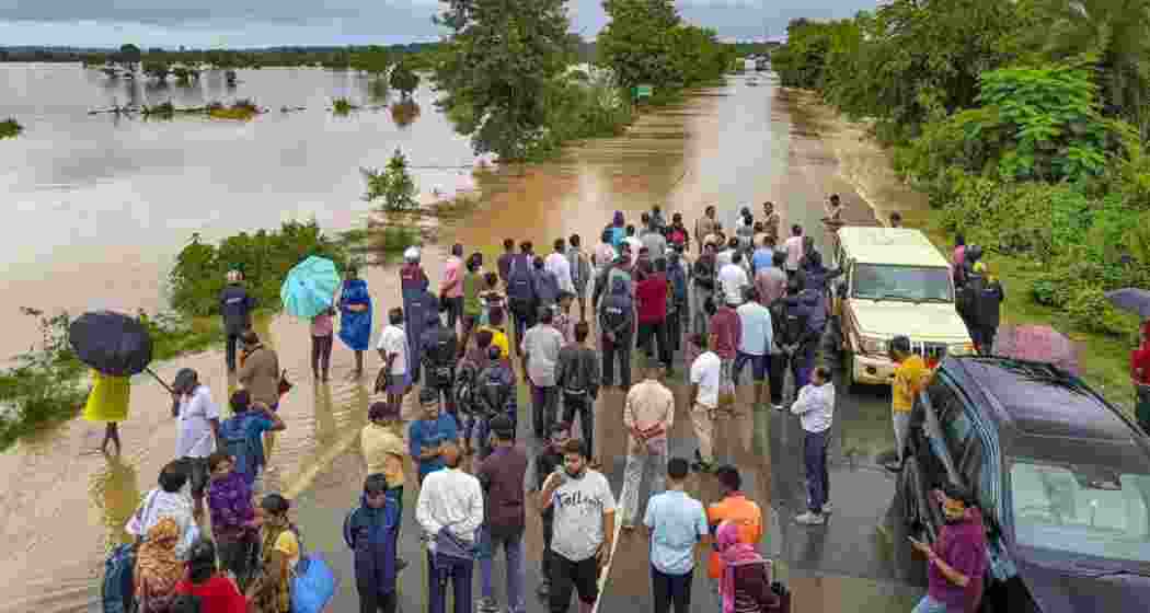 Villagers wade through waterlogged streets in Bastar, Chhattisgarh. 