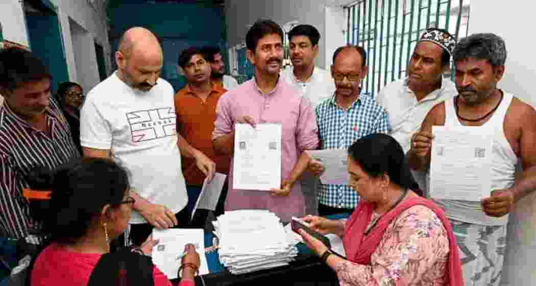 Booth Level Officers in Bihar verify documents during the Special Intensive Revision of the electoral rolls launched by the EC to weed out ineligible voters from the list.
