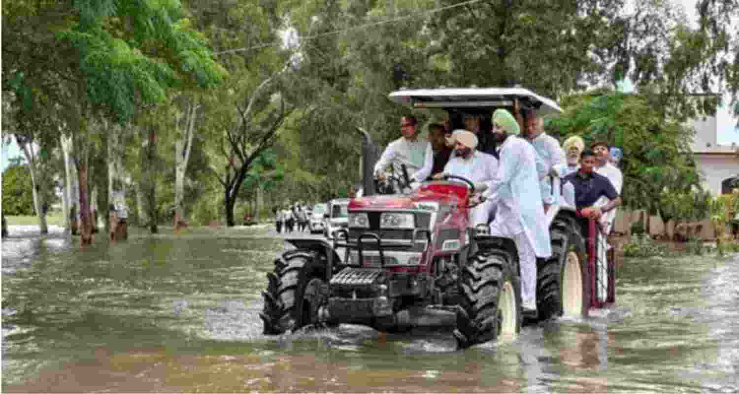 Union Agriculture Minister Shivraj Singh Chouhan, along with BJP leaders Ravneet Singh and Tarun Chugh, riding on a tractor during an inspection of a flood-affected area in Ramdass, Amritsar, on Thursday.