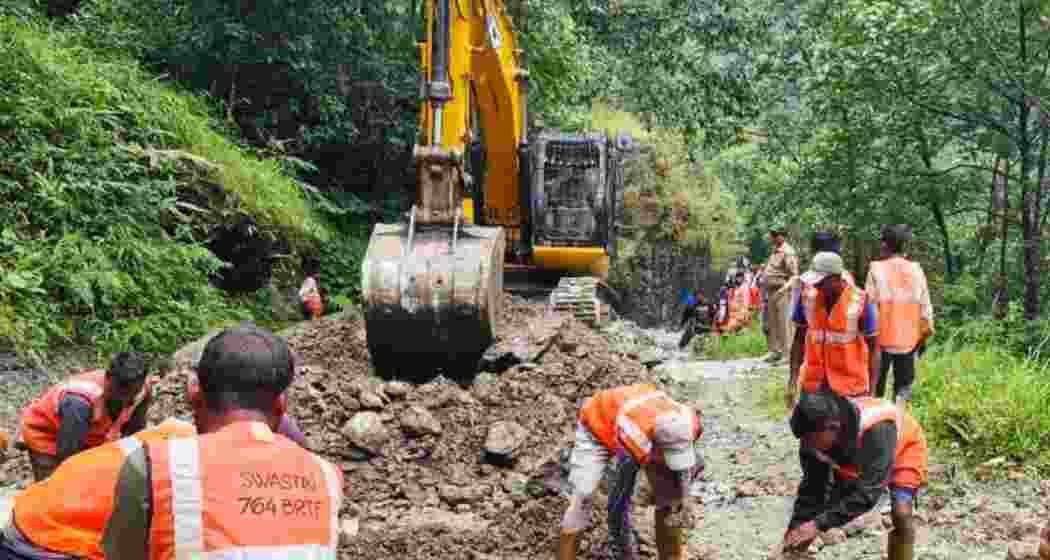 BRO personnel clear landslide debris at Taramchu in North Sikkim as authorities coordinate evacuation of stranded tourists and work to restore disrupted road connectivity in the region.