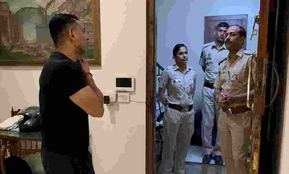 Activist Tehseen Poonawalla speaks to Delhi Police personnel at his residence.
