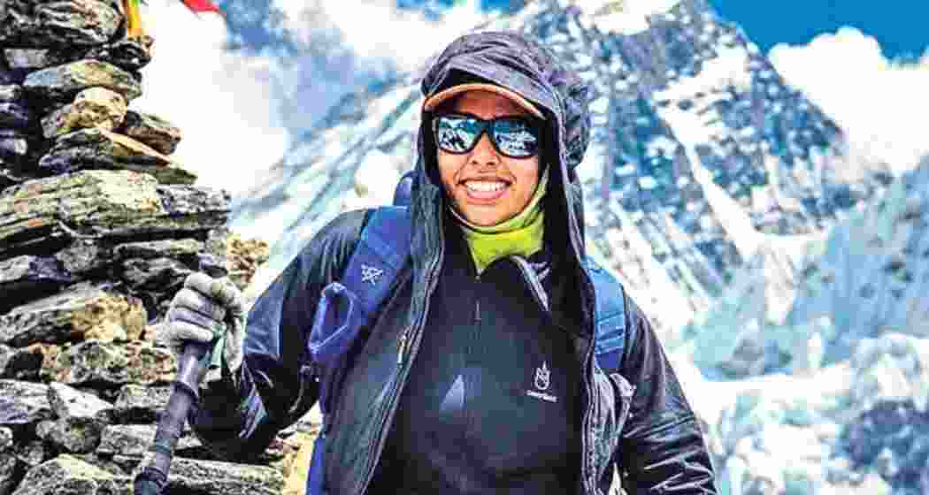 Nisha Shasikumar smiles atop Mount Everest after becoming the youngest person to scale the world's highest peak from the south route.