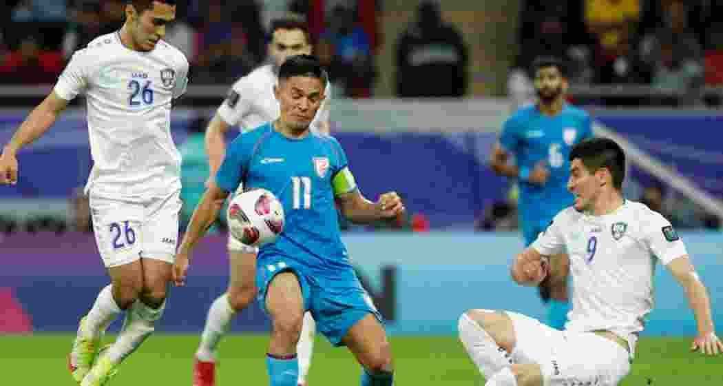 Sunil Chhetri challenges a Uzbek opponents for the ball during a match.