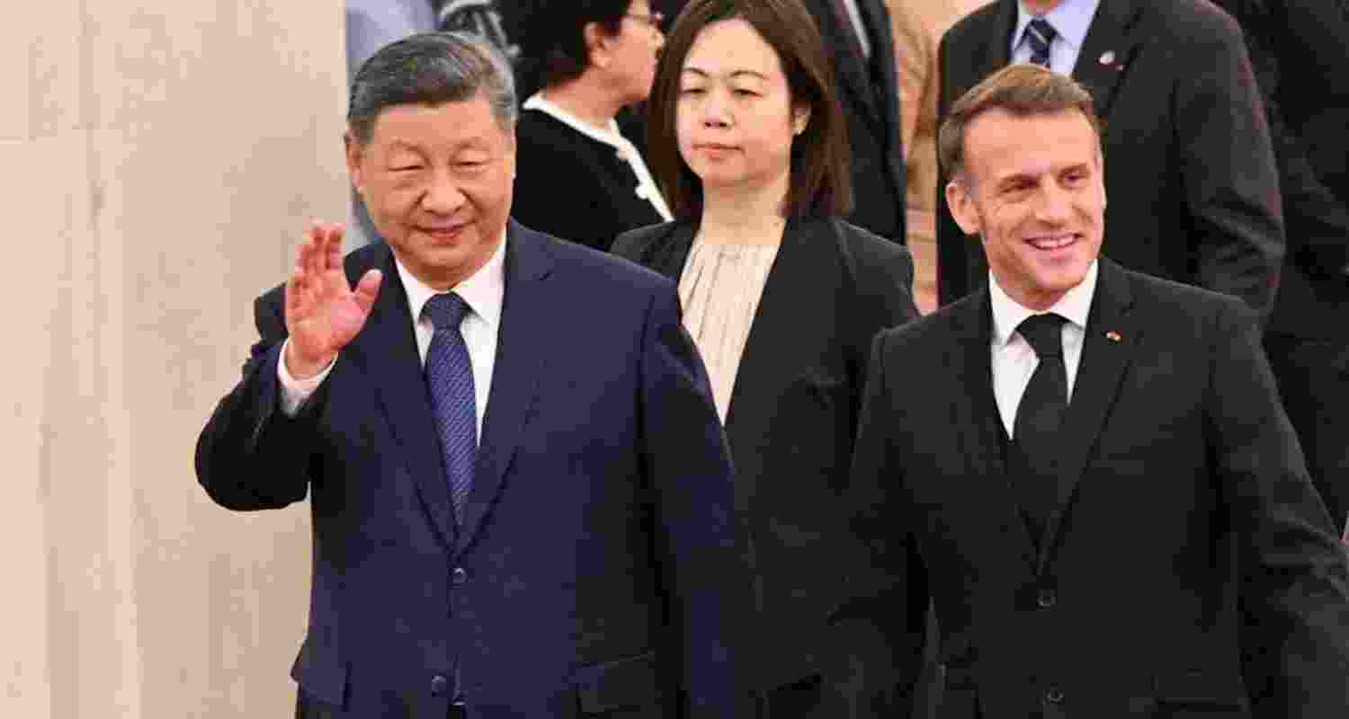 China's President Xi Jinping and France's President Emmanuel Macron attend a welcome ceremony at the Great Hall of the People in Beijing.